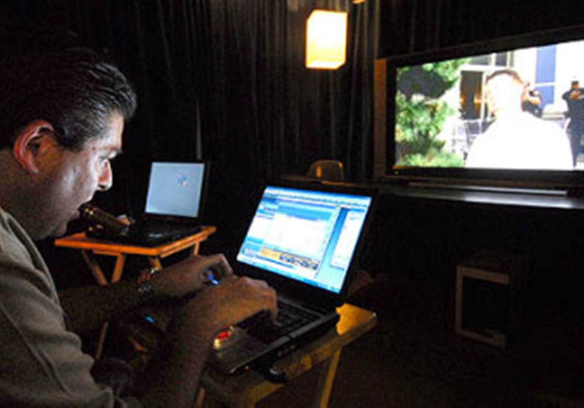 Mike Wittlin, president and chief executive officer of Smithfield Street Productions, watches scenes and makes notes at his office in Green Tree.