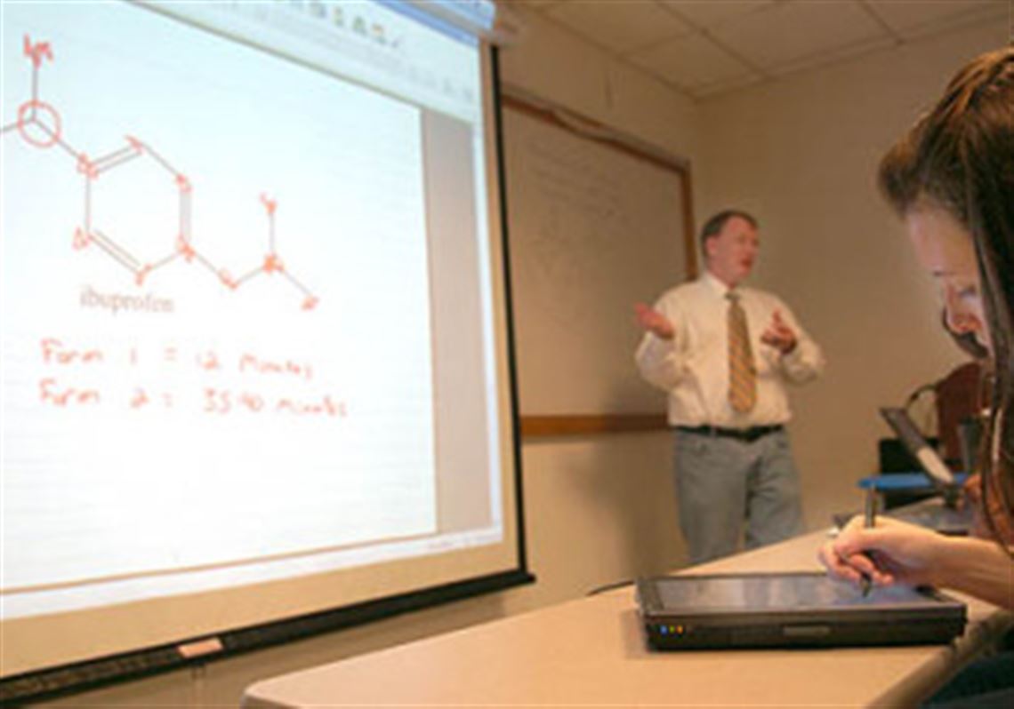 Jacqueline Regan, a junior chemistry major at Chatham University, takes notes on a tablet PC during Corey Stilts' organic chemistry class, which uses wireless Internet.