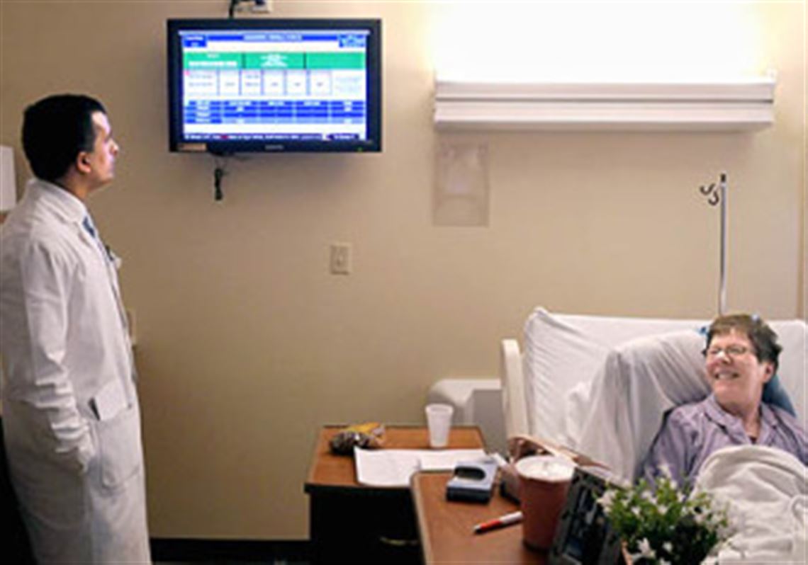 Dr. Shuja Hassan, a UPMC geriatrician, views a screen at UPMC Shadyside with information on patient Carmella Sacramento, 73,  from Swissvale.