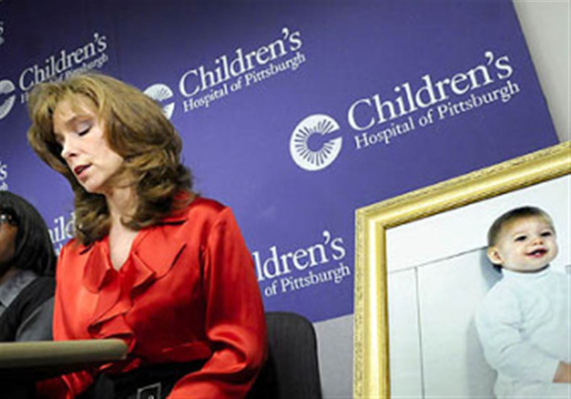 Mary Beth Hacke, whose son Ryan was killed in a shooting in Homestead in 1997, participates in yesterday's news conference on gun legislation at UPMC Children's Hospital.