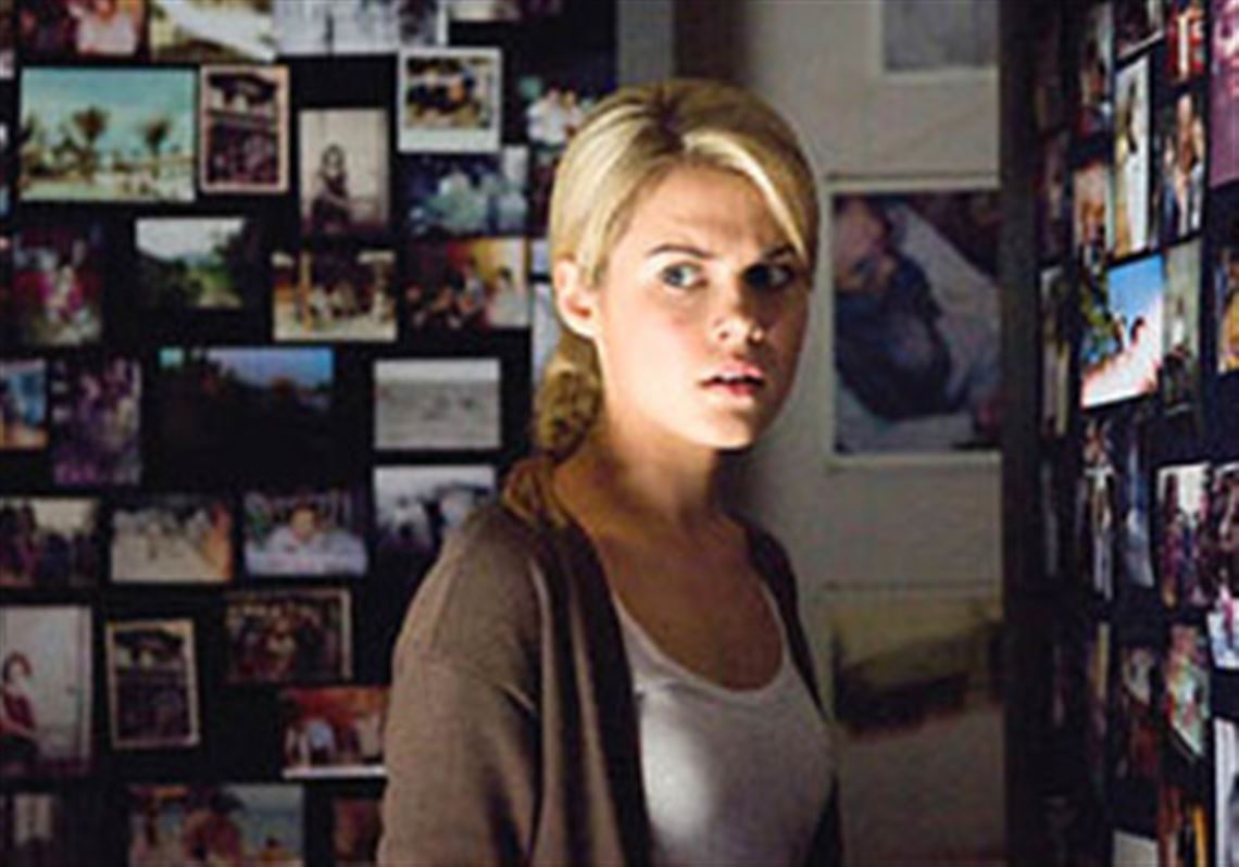 Rachael Taylor is troubled by a room full of disturbing spirit photography imagery in "Shutter."
