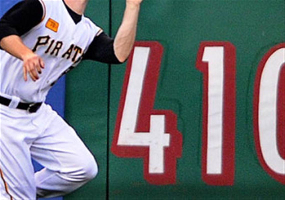 Jason Bay runs down a ball hit to deep left-center by Washington's Lastings Milledge in the fifth inning last night at PNC Park.
 Matt Capps wipes his brow after allowing Lastings Milledge's go-ahead two-run homer in the ninth.