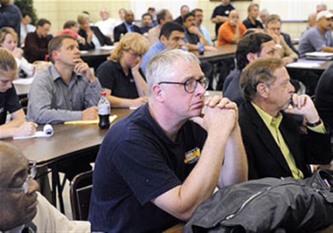 Bob Kostreva, center, a Clairton Coke Works employee, is among the crowd that gathered in Clairton last night to hear testimony about the plan to revamp the facility.