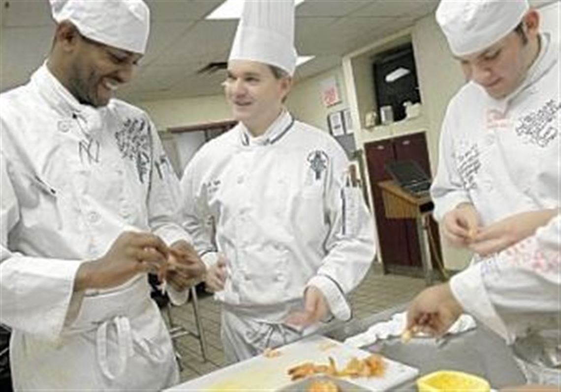 Chef Scott Fetty, center, talks with students Terrence McRae, left, 20, and Andrew Buonavolonta, 19, at the Pennsylvania Culinary Institute.