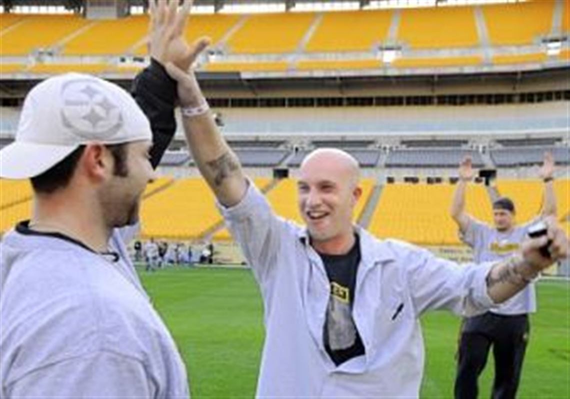 Steelers kicker Jeff Reed, left, celebrates with Army Sgt. Rob Bush, 35, of Grove City, after Sgt. Bush kicked an extra point. He served in Iraq in 2003 and 2005. See the photo journal Heroes at Heinz for more images.