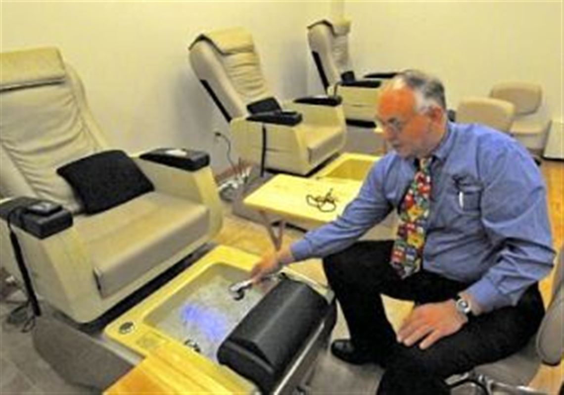 Dennis McCarthy, adult education coordinator at Steel Center, fills a pedicure foot basin that is part of a massage chair in the newly completed facilities of a day spa.