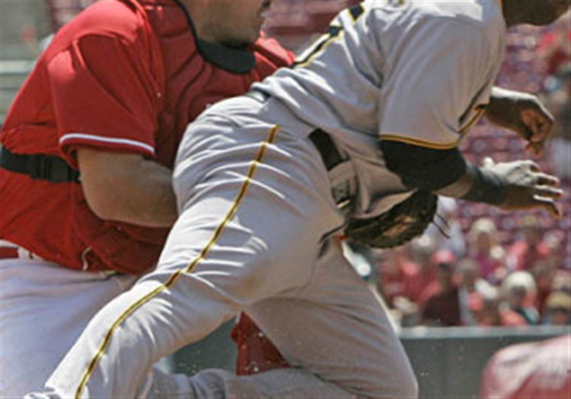 Reds catcher Corky Miller tags out Pirates outfielder Lastings Milledge at home in the fourth inning during yesterday's game in Cincinnati.