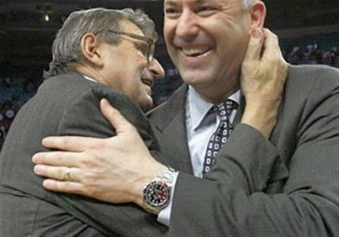 Penn State football coach Joe Paterno, left, congratulates Penn State basketball coach Ed DeChellis after the NIT championship college basketball game against Baylor in April in New York. Penn State won 69-63.