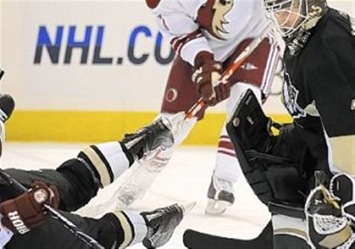 Penguins goalie Brent Johnson makes save on Phoenix's Petr Prucha in a game earlier this month.