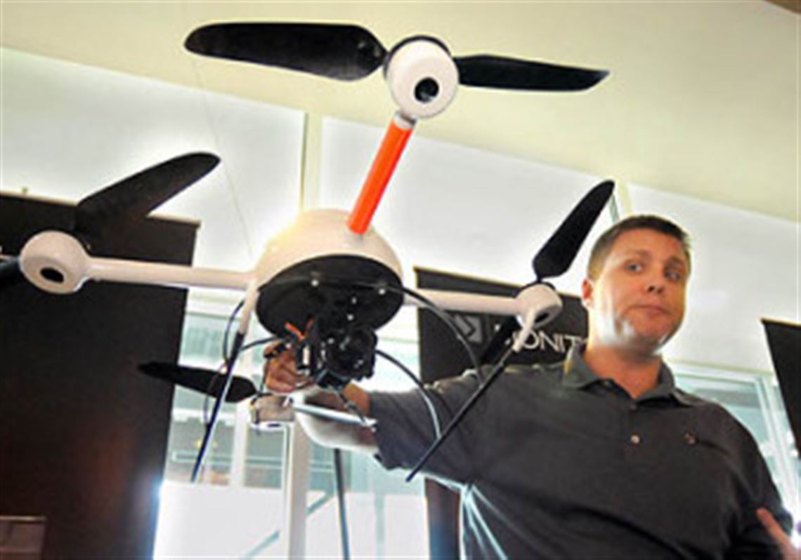 Duane Stokes of Tactical Electronic shows off the company's mini surveillance helicopter that can carry a TV camera and be operated by officers at an incident scene. The helicopter is made of carbon fiber and weighs just ounces. It operates on the hobby frequencies and can be easily flown at heights up to 400 feet. The basic system costs $40,000.