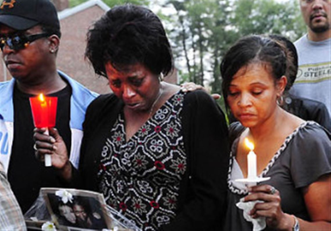 Kathy King, center, mother of shooting victim Lynna Flippen, and Constance King, the victim's aunt, right, stand in front of the family home during a vigil.