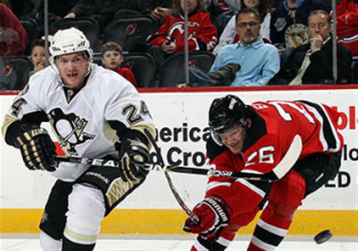 Penguins forward Matt Cooke shoots the puck past Devils forward Patrik Elias at the Prudential Center in Newark, N.J. tonight.