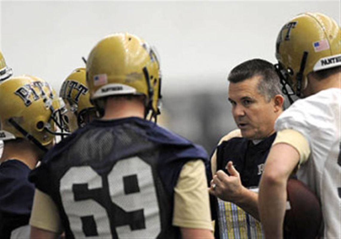 New Pitt head coach Todd Graham talks with a group of players during the first day of spring practice at the UPMC Sports Performance Complex on the South Side.