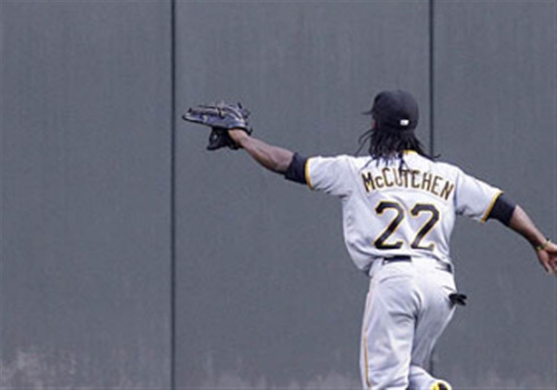 Andrew McCutchen chases a ground rule double hit by the Reds' Scott Rolen into center field in the second inning Monday.