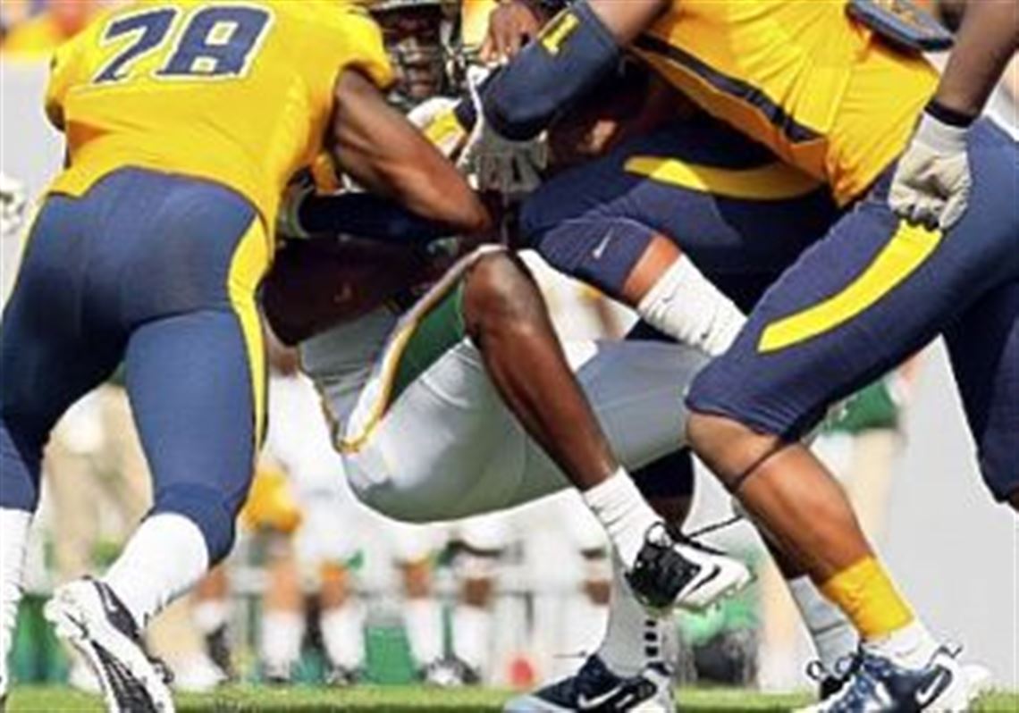 West Virginia's Terence Garvin, left, and Bruce Irvin drop Norfolk State quarterback Dexter Merritt in the second half Saturday in Morgantown, W.Va., as the Mountaineers pulled away.
 Geno Smith passed for four touchdowns Saturday.