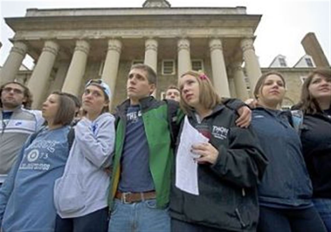 Penn State University students gather Thursday at Old Main, the school's administration building at the center of the campus, to express solidarity for the victims in the child abuse scandal involving former Penn State football coach Jerry Sandusky. Their vigil was a contrast to the rioting by students Wednesday night in reaction to head football coach Joe Paterno being fired as part of the university's reaction to the scandal.