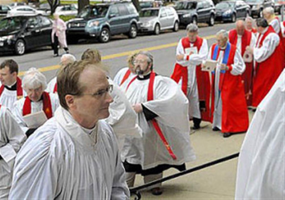 Bishop-elect Dorsey W.M. McConnell, front, processes up the steps to Calvary Episcopal Church in Shadyside for his ordination on Saturday.