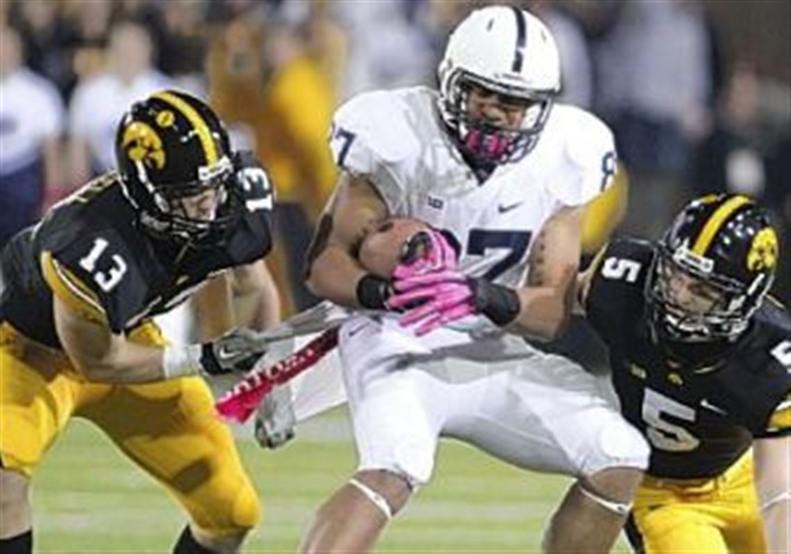 Kyle Carter makes a catch between Iowa's Tom Donatell, left, and Tanner Miller Saturday in Penn State's 38-14 win against the Hawkeyes in Iowa City, Iowa. Carter had six receptions for 85 yards.