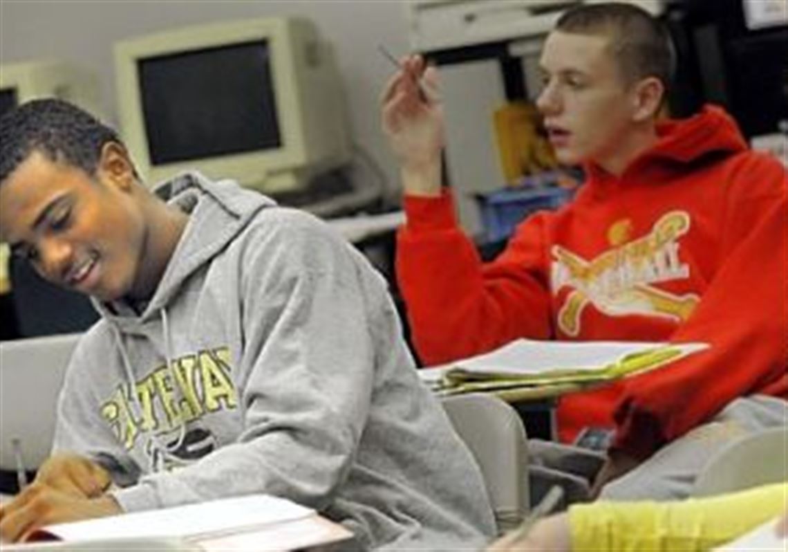 Delvon Randall, a junior at Boyce Campus Middle College High School, takes notes during class.