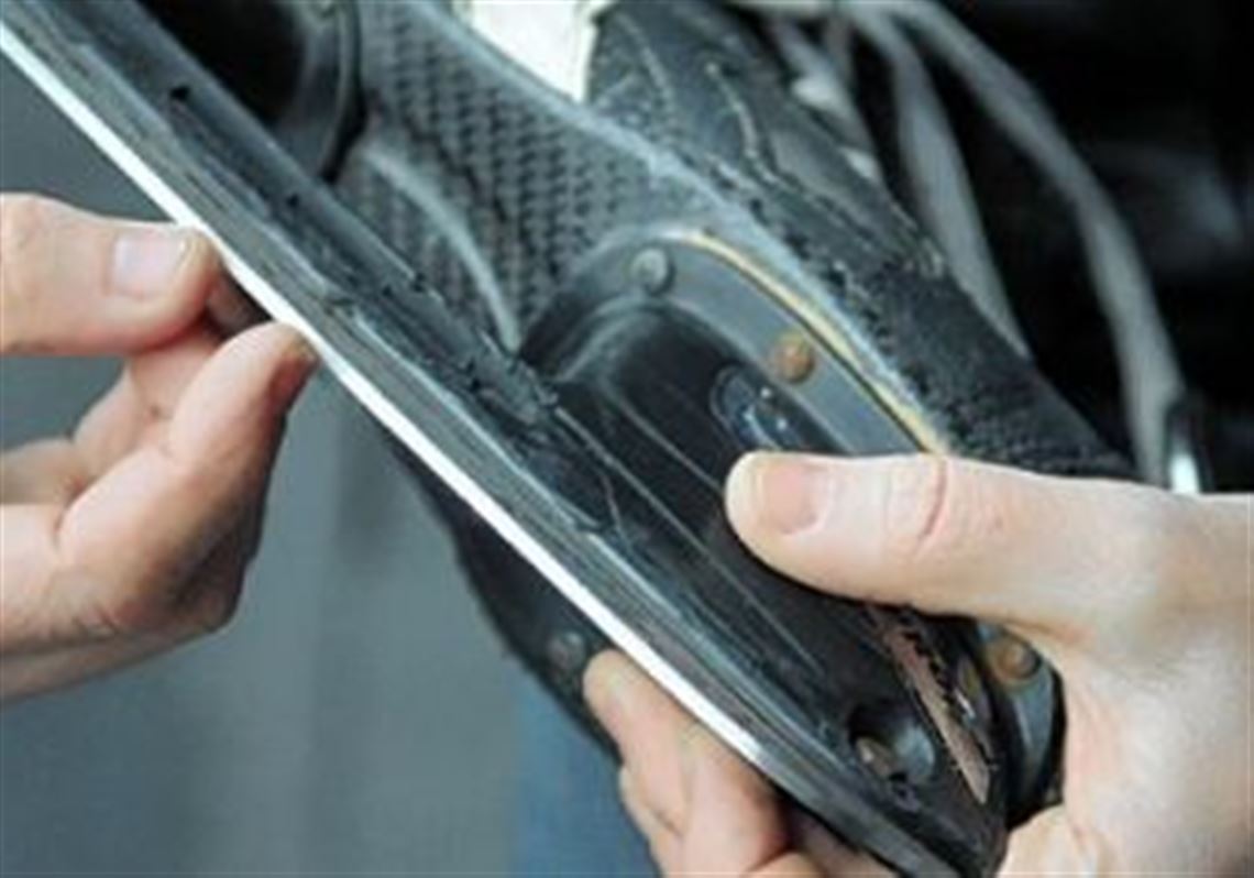Eric Swanson shows how skate blades have a thin channel down the middle, creating distinct inside and outside edges.