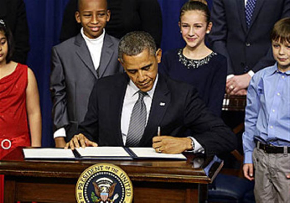 Hinna Zeejah, 8, Taejah Goode, 10, Julia Stokes, 11, and Grant Fritz, 8, who wrote letters to President Barack Obama about the school shooting in Newtown, Conn., watch as Mr. Obama signs executive orders today outlining proposals to reduce gun violence.
 