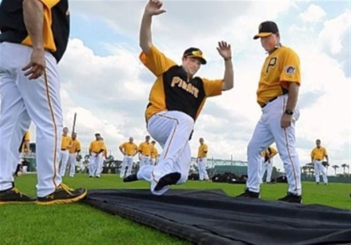Pirates second baseman Neil Walker goes hard into the sliding mat during workouts Friday at Pirate City in Bradenton, Fla.