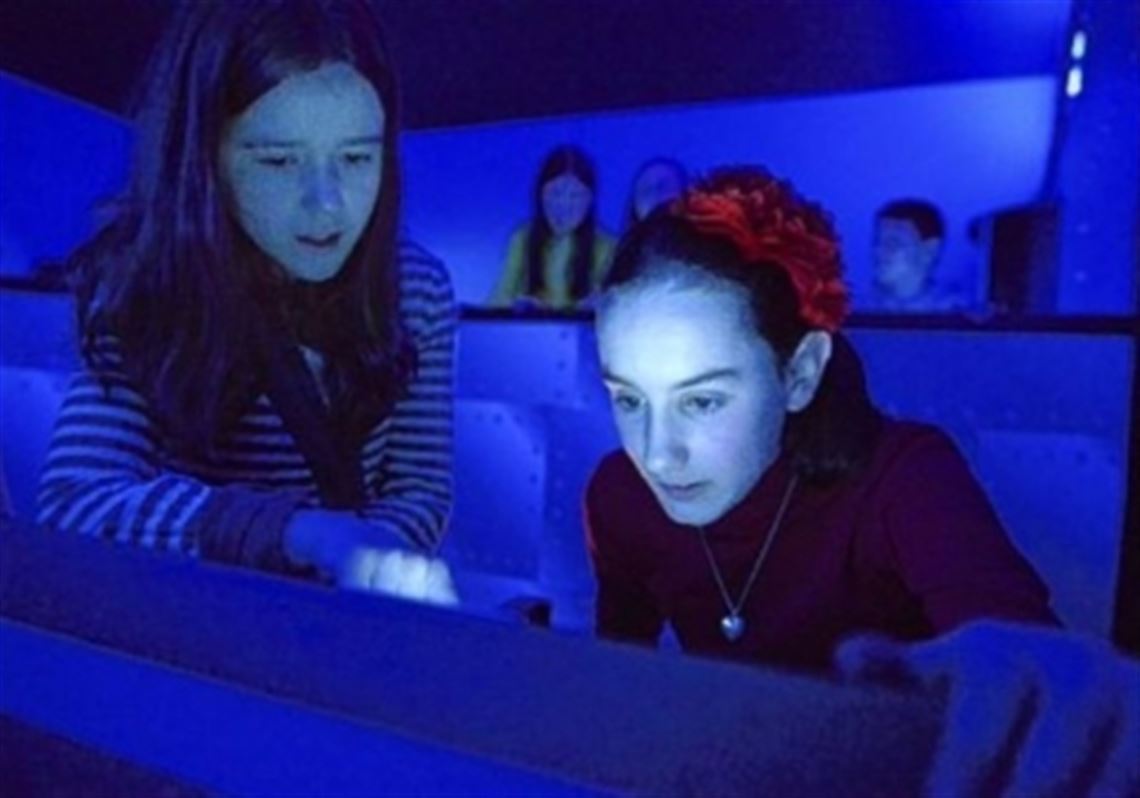 Fifth-graders Anna Rosso, 10, and Mary Flint, 10, use the simulator.