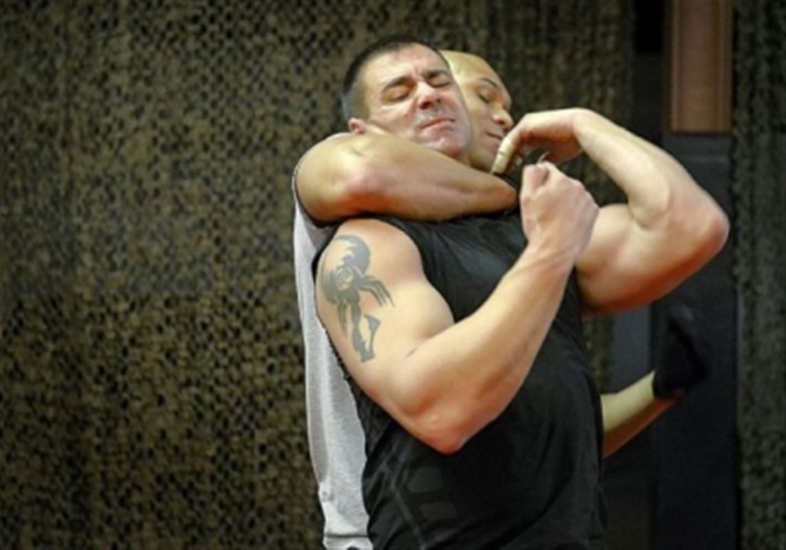 Patrolman Bob Pugar, front, of the Clairton Police Department, and patrolman Court Perkins of the Solon, Ohio, police are among a group of police officers learning the Israeli form of self-defense last week. The fighting system uses instinctive movements and practical techniques.