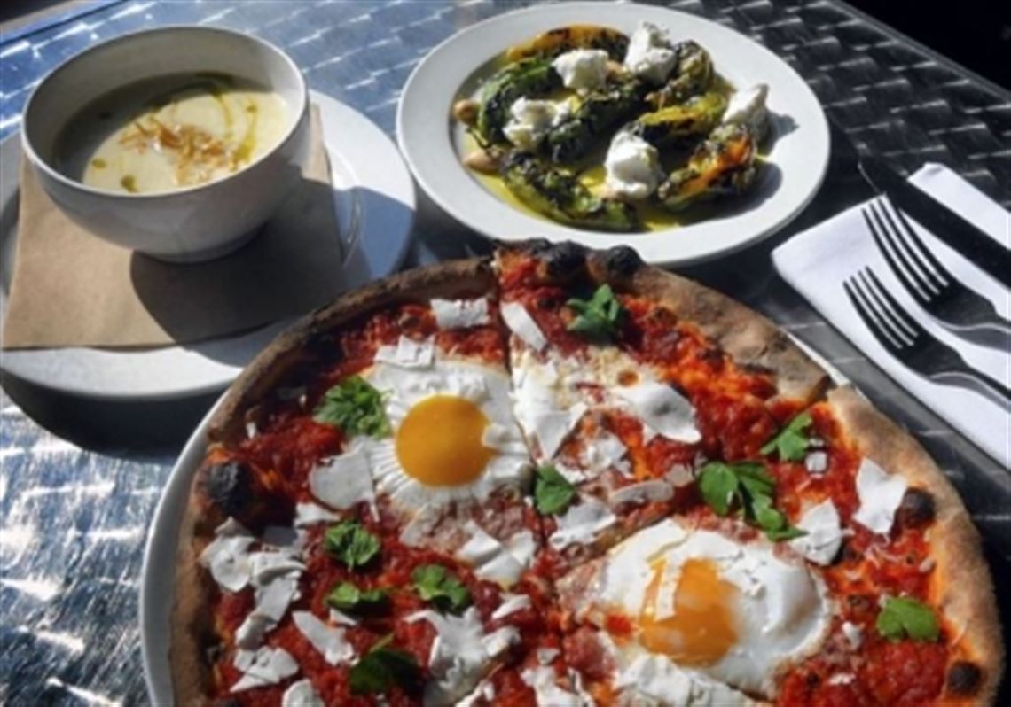 At Dinette in East Liberty: pizza with sunny-side-up eggs, parsnip cream soup, and grilled shishito peppers.