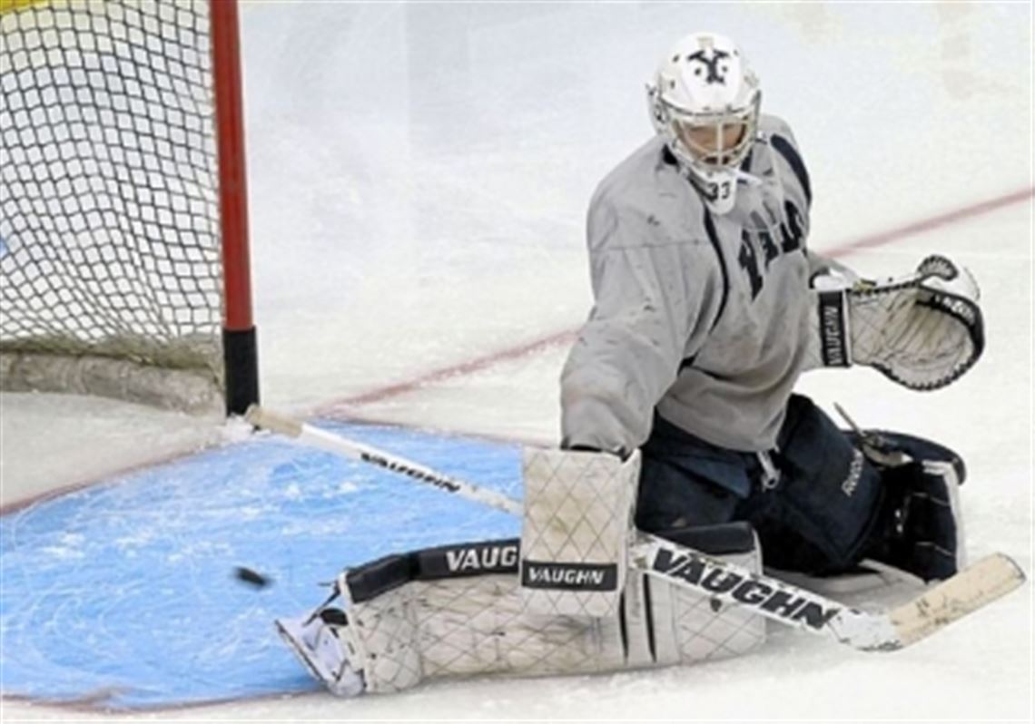 Yale goalie Jeff Malcolm deflects a puck during practice Friday at Consol Energy Center.