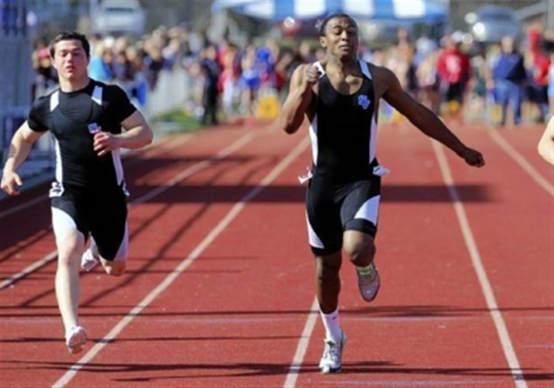Seneca Valley's Forrest Barnes, center, wins the boys 100-meter dash Friday at Mars High School.