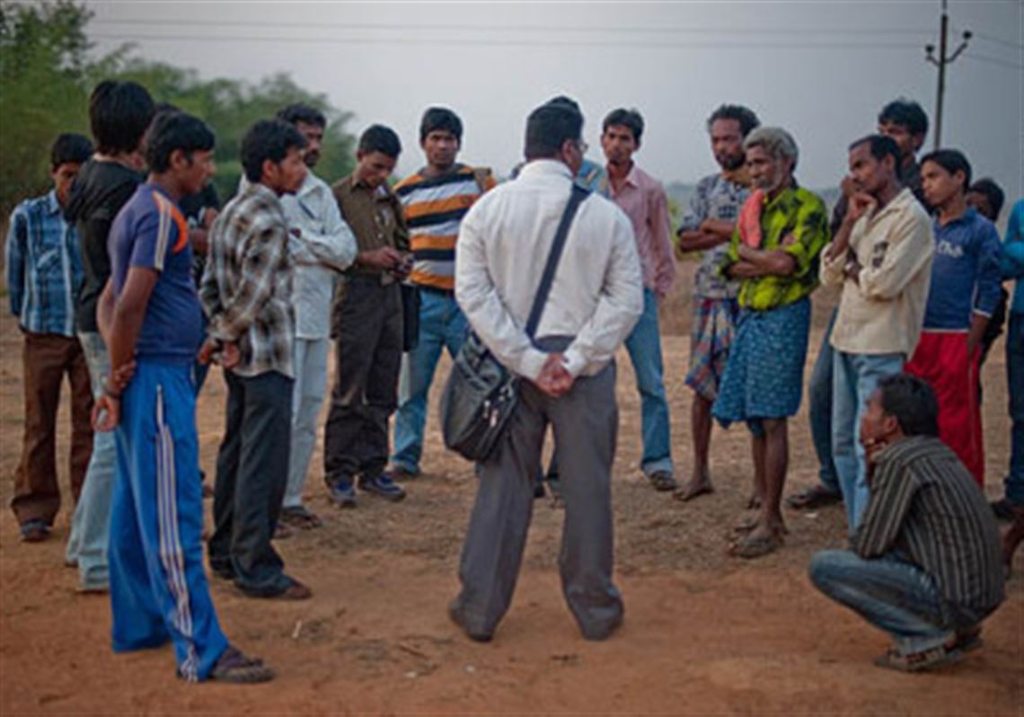 Members of the Koraput Survivors Project discuss masonry. The Christian community was forced by the Hindu majority to leave their homes and settle here. The photography show is at 707 Penn Gallery.
