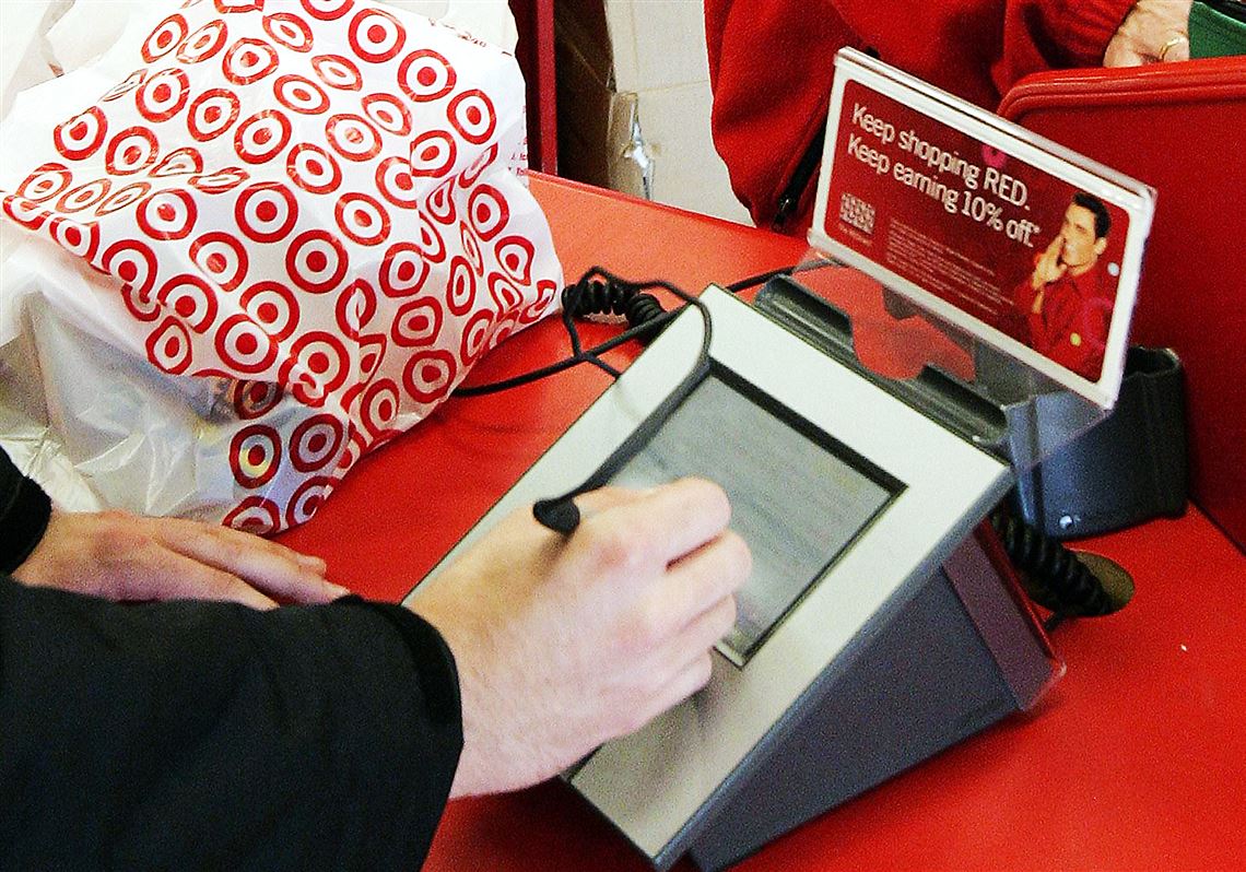 A customer signs his credit card receipt at a Target store in Tallahassee, Fla.