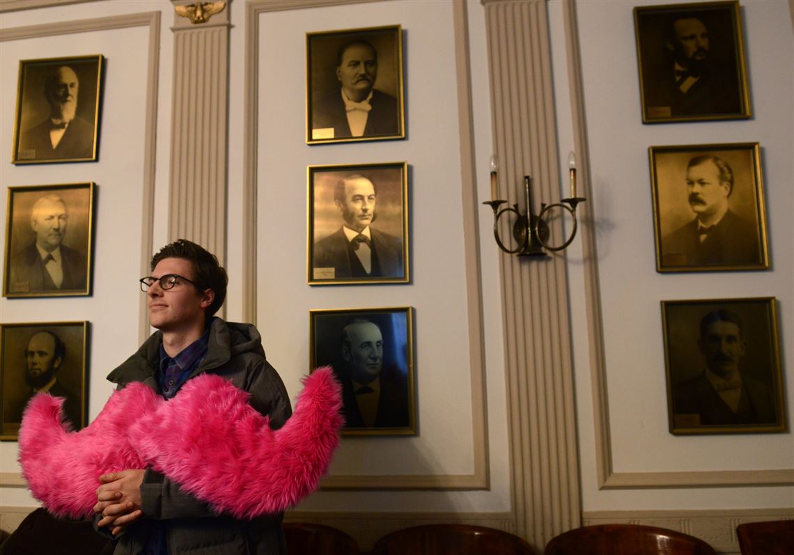 Will Farino, part of the launch team for Lyft in Pittsburgh, listens to Mayor Peduto during a news conference Tuesday where he expressed his support for competition in the public transportation market.