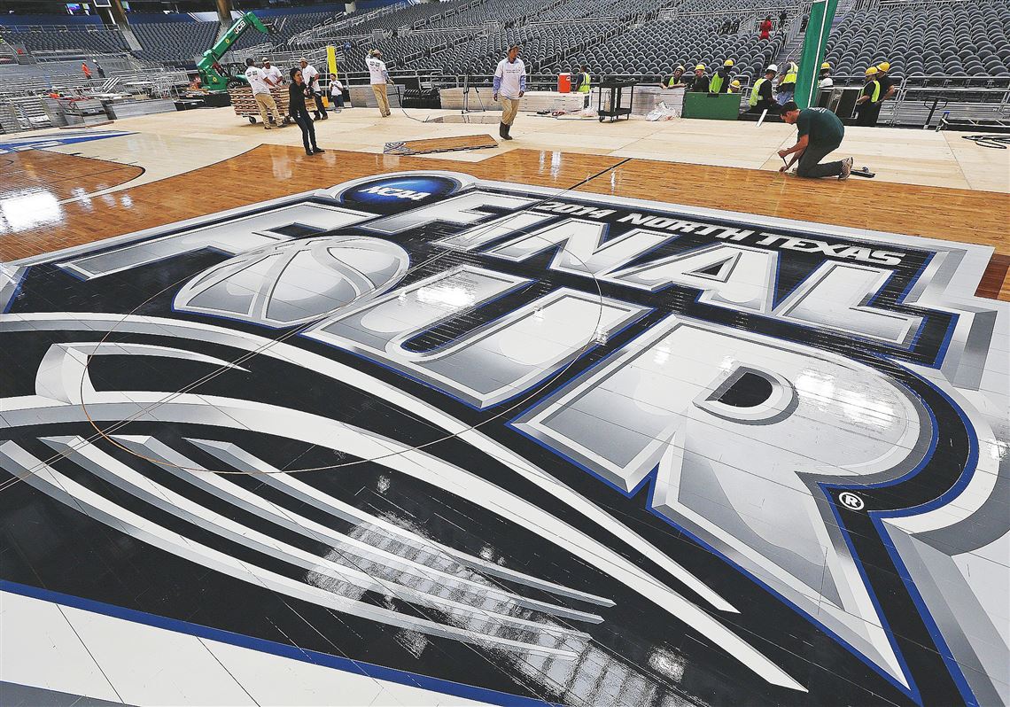 Workers assemble the NCAA's Final Four floor Friday at AT&T Stadium in Arlington, Texas.