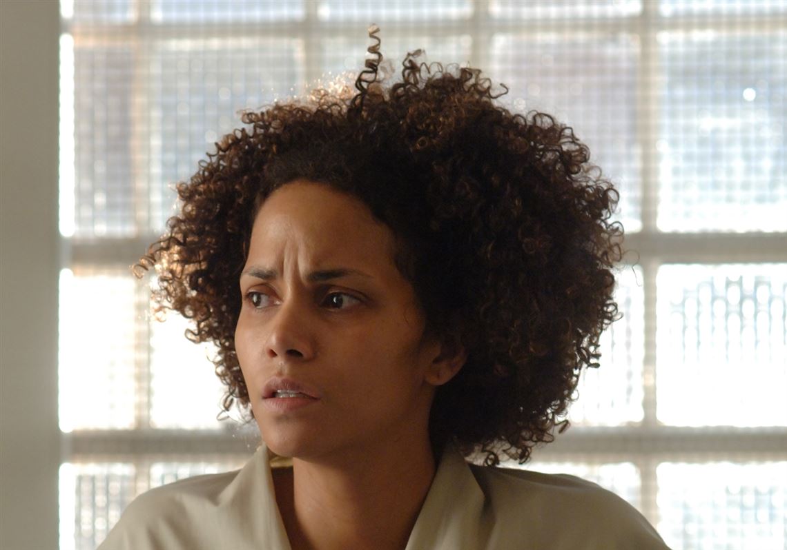 A stunned Frankie (Halle Berry) is mesmerized by recent news in "Frankie & Alice." 