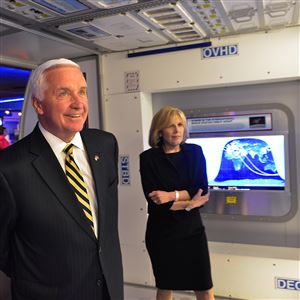 While on a tour of the Carnegie Science Center on Monday, Pennsylvania Gov. Tom Corbett takes a look at the mock-up of the International Space Station. At rear is science center co-director Ann Metzger.