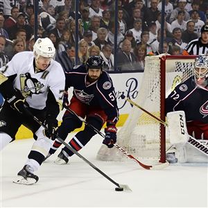 The Penguins' Evgeni Malkin wraps the puck around the net in front of Blue Jackets goalie Sergei Bobrovsky.