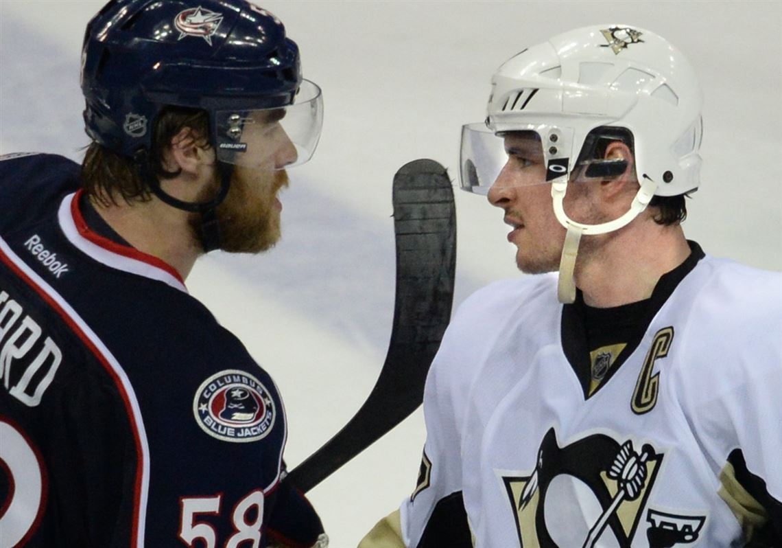 Sidney Crosby shakes hands with David Savard after the Penguins eliminated the Blue Jackets with a 4-3 win Monday at Nationwide Arena in Columbus, Ohio.