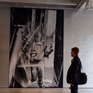 The Andy Warhol Museum first-floor remodeling in 2013 includes a floor-to-ceiling photo of Andy pulling an acetate of Marilyn Monroe. 