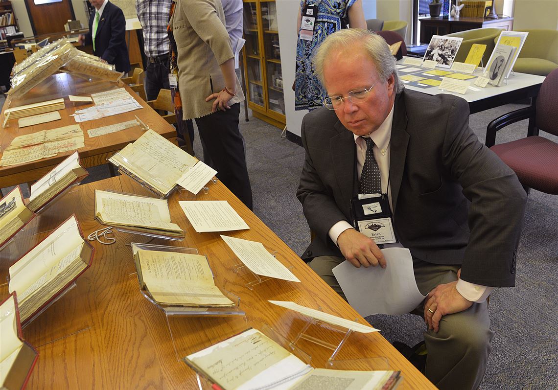 Brian Hardison  of Powder Springs, Ga., takes a close look at an account of the trial and acquittal of Aaron Burr, which was on display at the Hillman Library for members of the Manuscript Society to view Thursday.