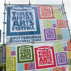 Sarah Morrow of Flyspace Productions checks the framework after making sure that all of the portions of the Three Rivers Arts Festival signs are secure as the festival area is readied for the opening on Friday.