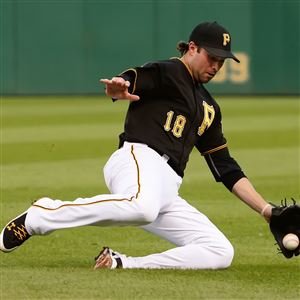 Pirates second baseman Neil Walker dives for a ball hit by the Dodgers'  Dee Gordon, who was called out at first at PNC Park Monday night.