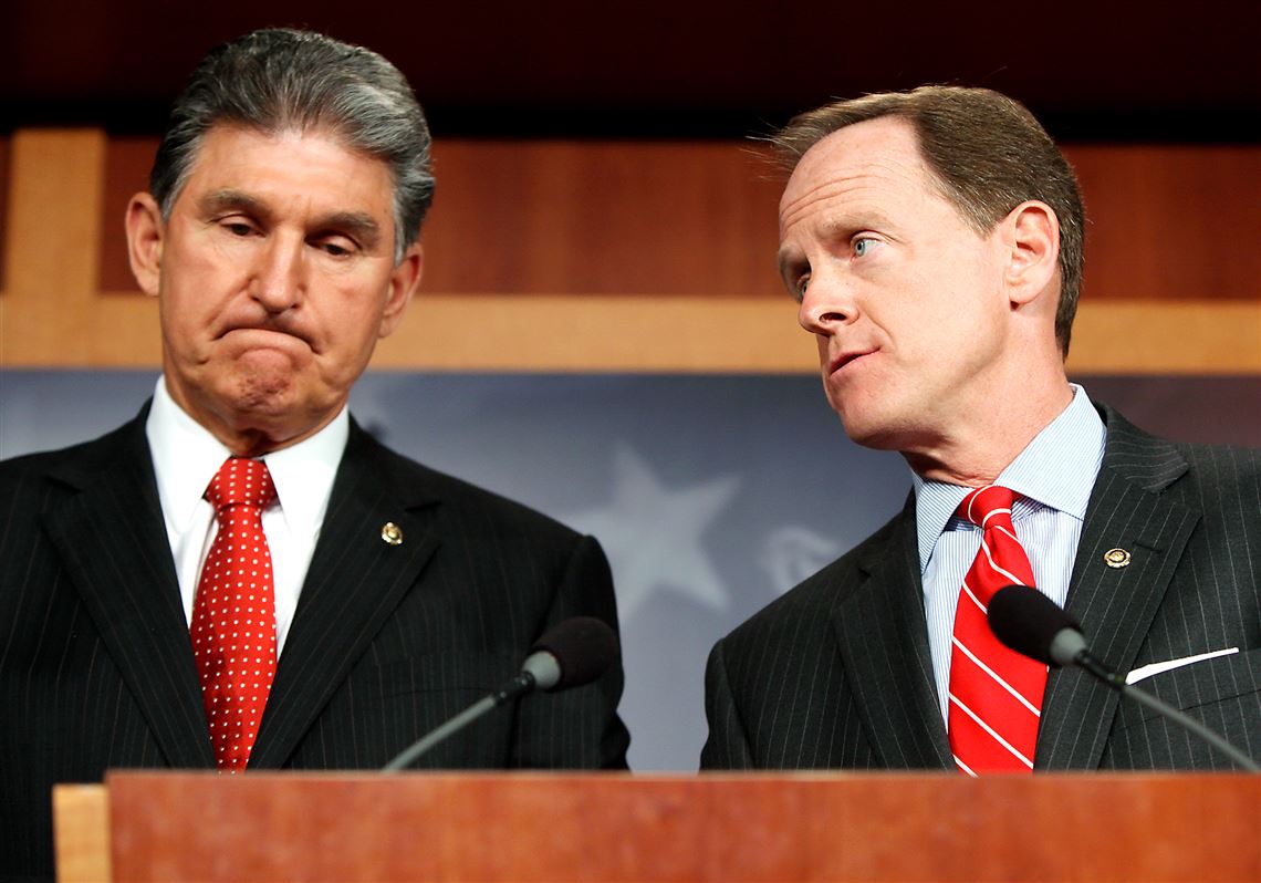Sen. Joe Manchin, left, D-W.Va., and Sen. Pat Toomey, R-Pa., speak in April about background checks for gun purchases. The pair’s proposal was ultimately rejected, but their new bipartisan compromise requires more background checks for public school employees. 