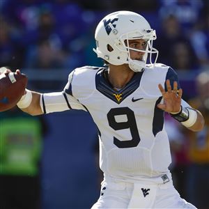 In this Nov. 2, 2013, file photo, West Virginia quarterback Clint Trickett prepares to pass against TCU during the first half of an NCAA football game in Fort Worth, Texas. West Virginia is 11-14 over the past two seasons and must show significant improvements on both sides of the ball to avoid another year of disappointment. The offense will rely on  Trickett, who started seven games a year ago and is coming off shoulder surgery in the offseason.