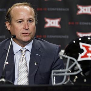 West Virgina head coach Dana Holgorsen  answers a question from a reporter during the NCAA college Big 12 Conference football media days in Dallas, Tuesday, July 22, 2014.