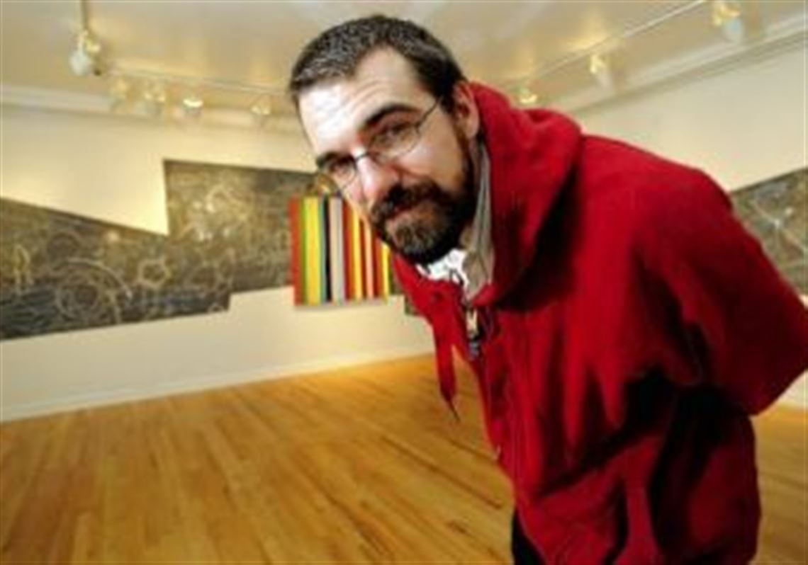 Biennial curator Adam Welch, shown here in 2008 with his work "Self portrait as an equation (fractioned/askew)," when he was named Emerging Artist of the Year at the Pittsburgh Center for the Arts.