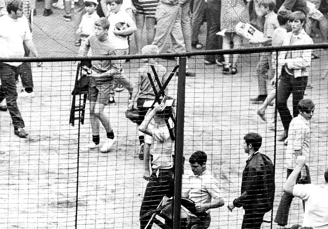 Fans claim pieces of Forbes Field after the last game there.
