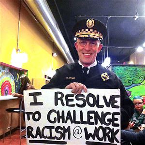 Pittsburgh Police Chief Cameron McLay on New Year's Eve, holding a sign offered by the local activist group What's Up?! Pittsburgh. The photo was widely circulated on social media.