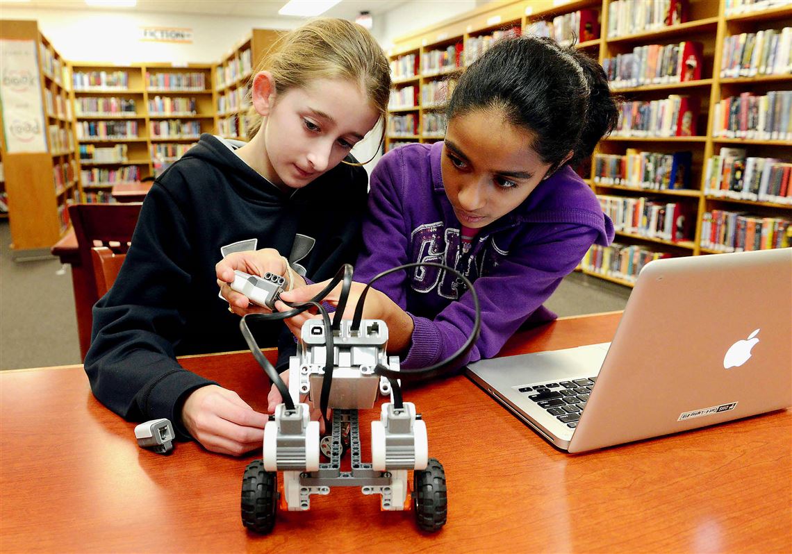 From left, 6th graders Kayleigh Ferderbar, 12, and Vinisha Sant, 11, work to program a robot during the Fox Chapel Area School District's RoboClass 101, which teaches the basics of robots design and programming, at the Dorseyville Middle School on Dec. 18, 2014.  